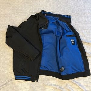 Tommy Hilfiger Men’s black jacket with self storing hood.